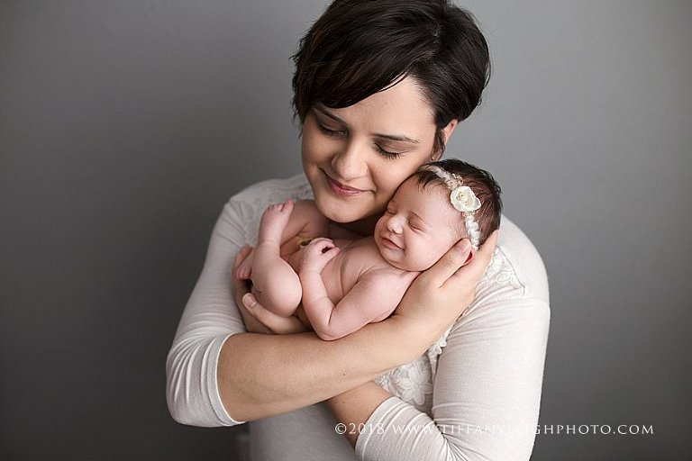 A new mother holds her baby close. 