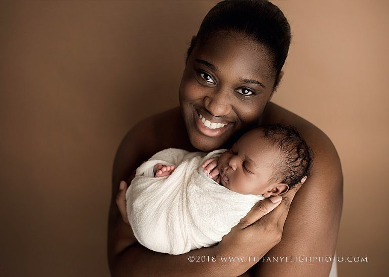 A parent holds a new baby. 