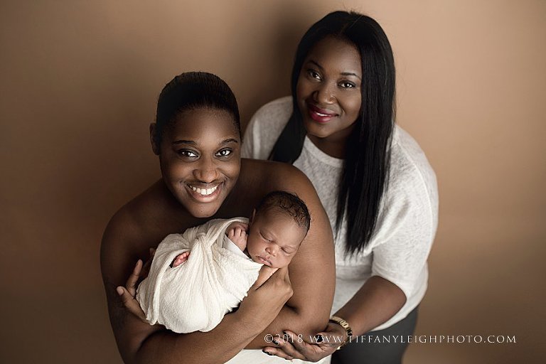 Two parents smile with their new baby | Gainsville Newborn Photography