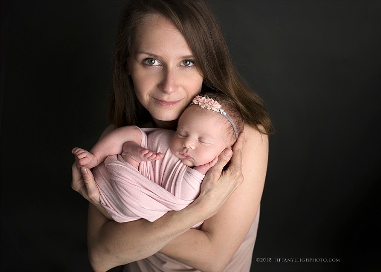 A new mother holds her baby close to her face