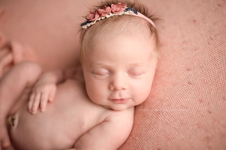 A baby gives a smile in her sleep