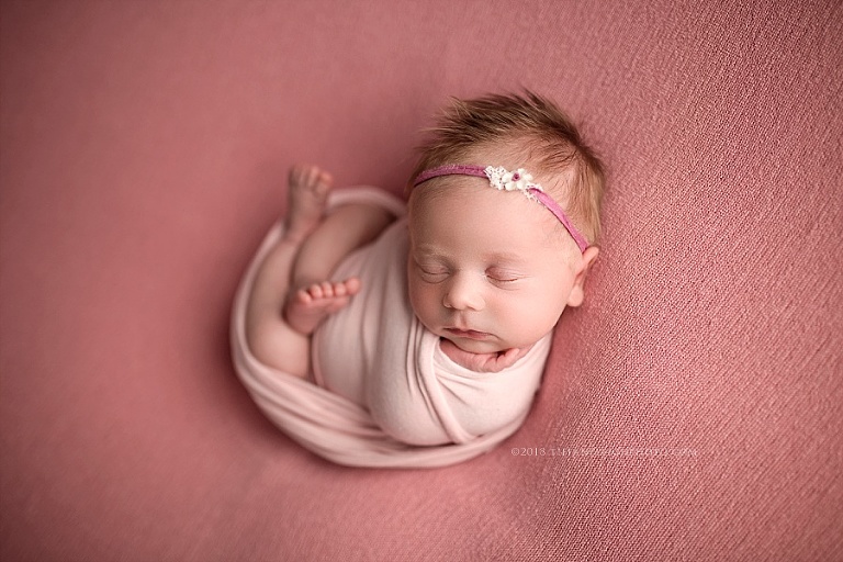 A little baby's feet are twisted into a pretzel