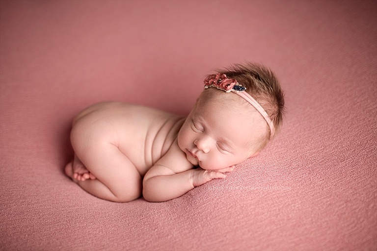 A baby sleeps on her stomach. 