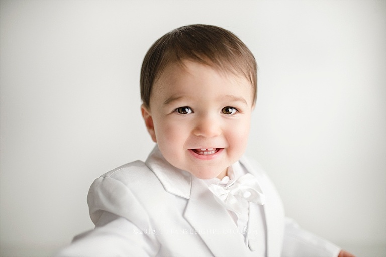  A baby boy reaches out his hand to the camera during his Gainsville Baby Photography session. 