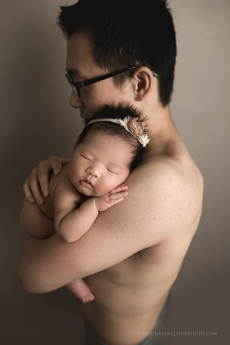 newborn in daddy arms