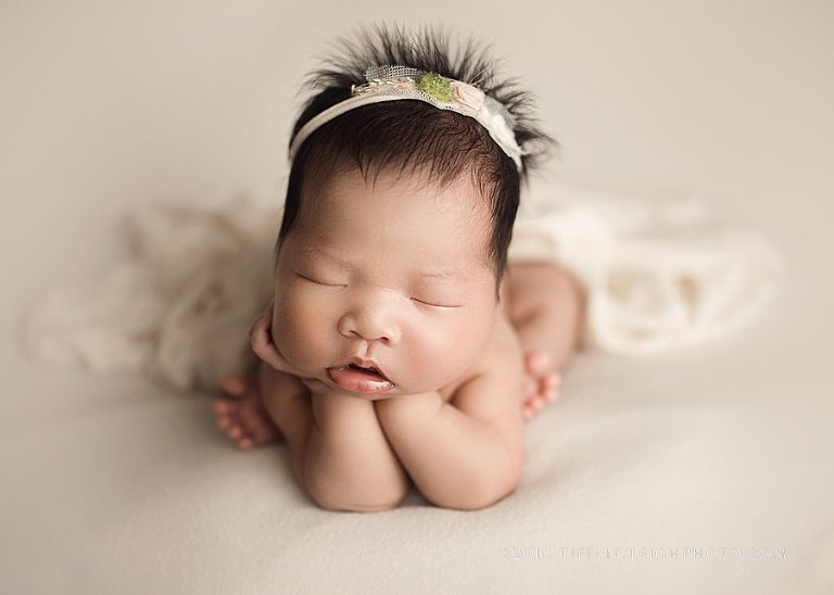 newborn froggy pose with baby girl