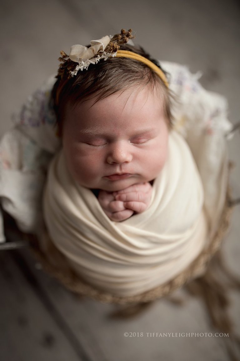 baby girl wrapped in bed