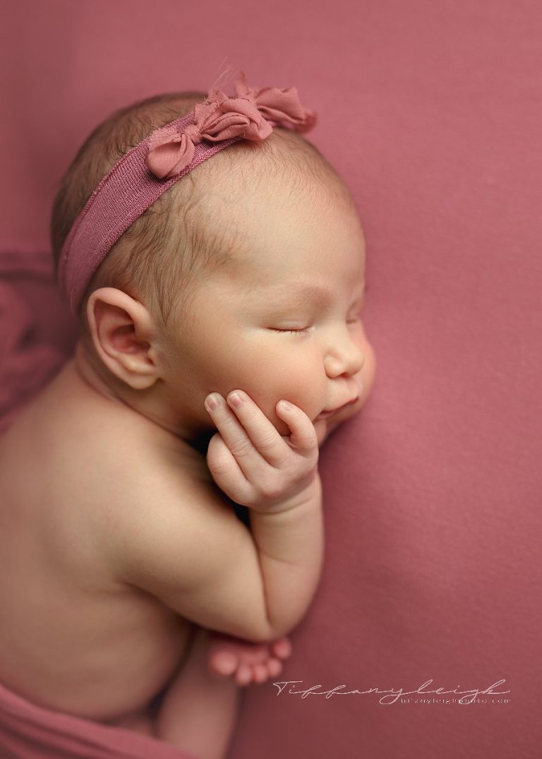 newborn girl on pink