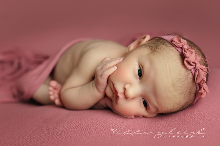 newborn girl on pink