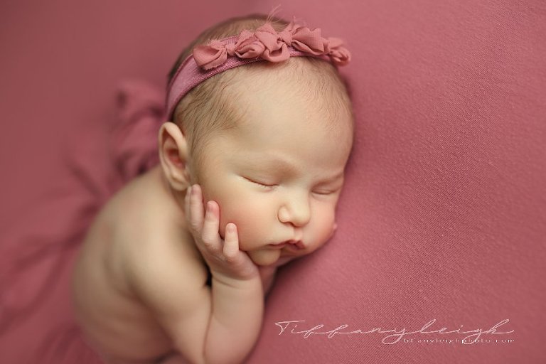 newborn girl on pink