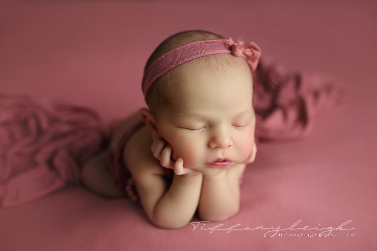 newborn girl on pink