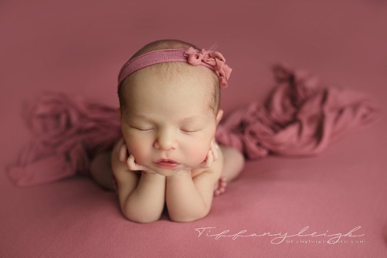 newborn girl on pink