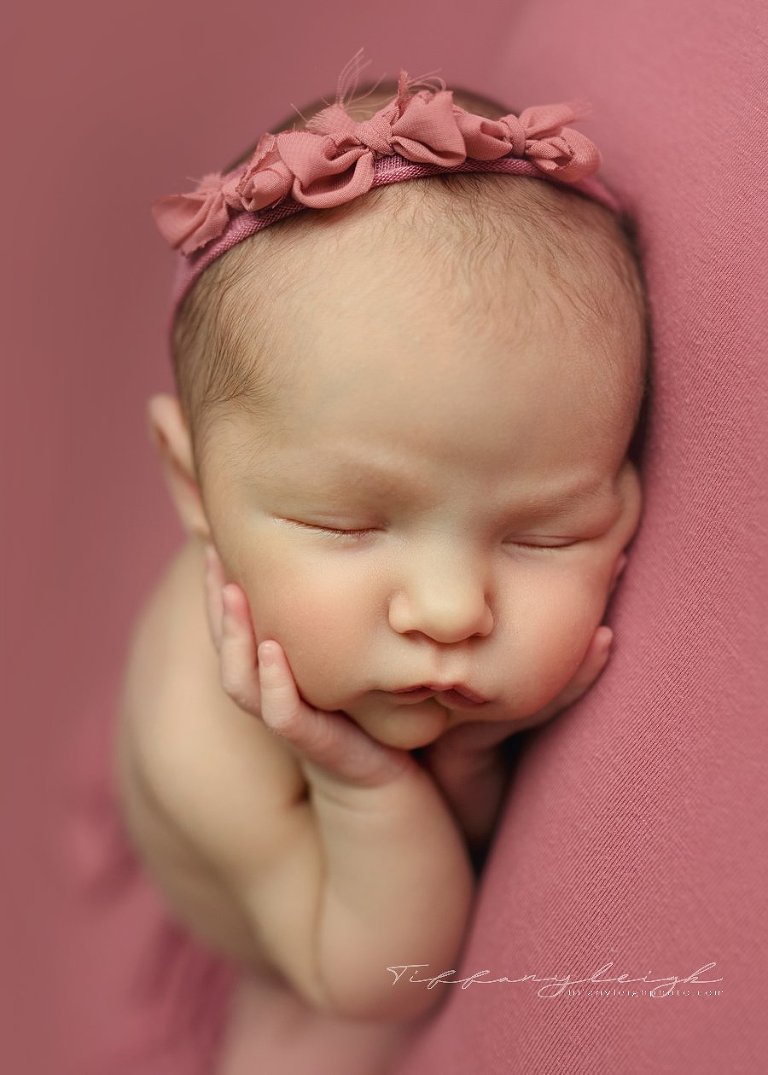 newborn girl on pink