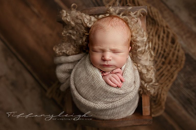 baby wrapped in bed newborn photography