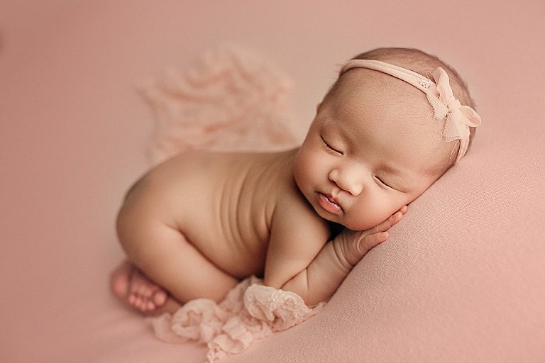 gainesville newborn girl on pink with headband