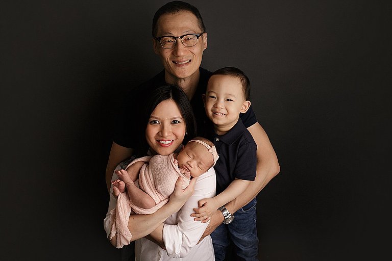 posed newborn family with sibling 