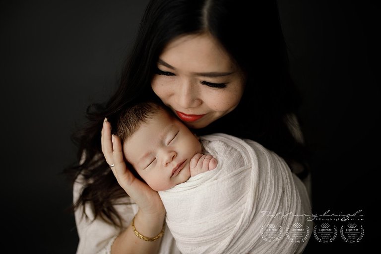 gorgeous new mom holding baby