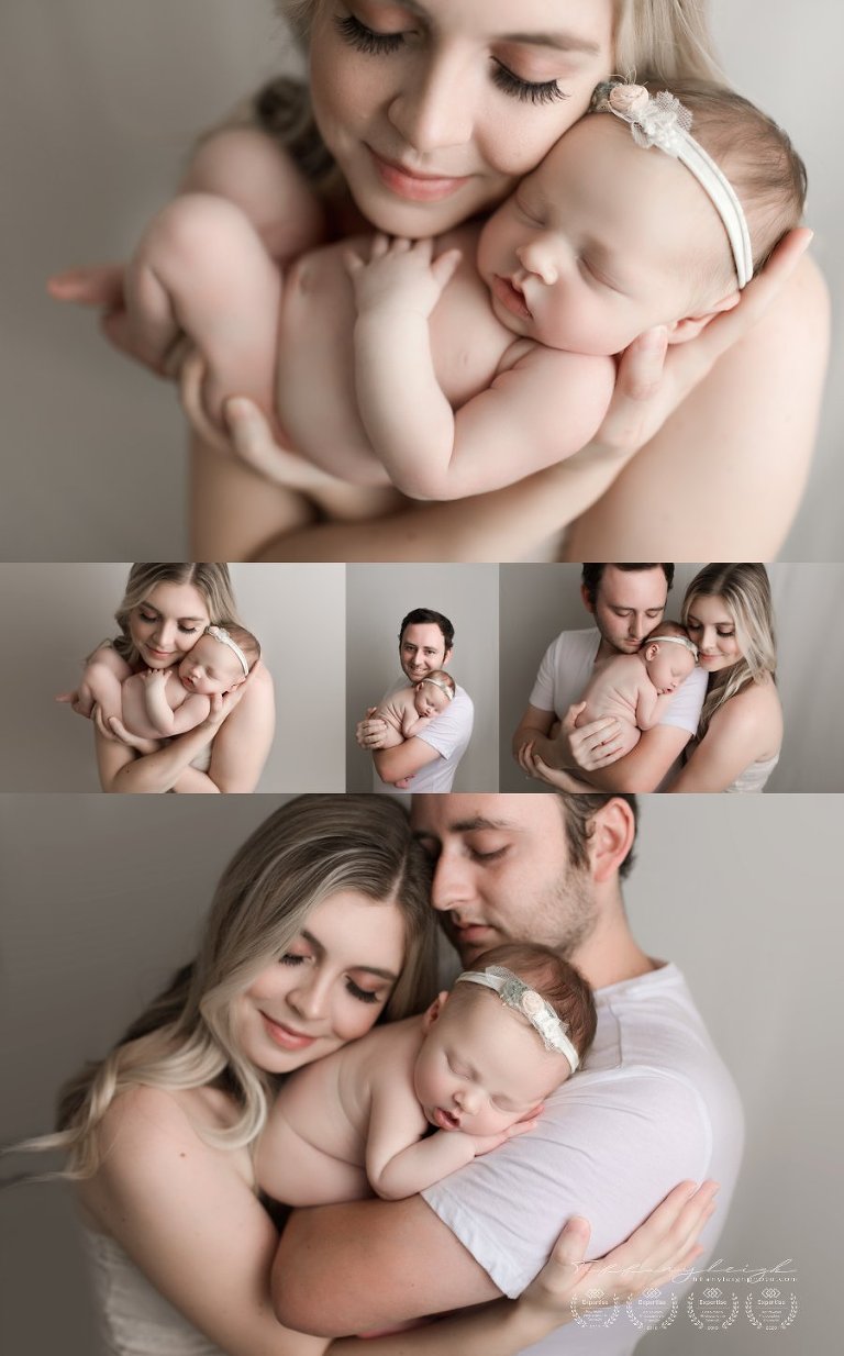 parent posing with newborn