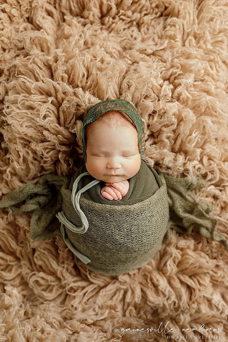 Baby wrapped on rug newborn photography gainesville fl