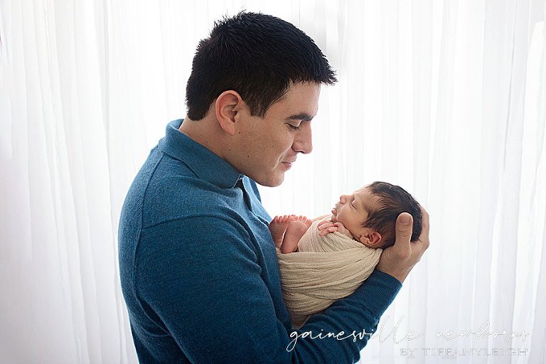 newborn son in daddy's arms