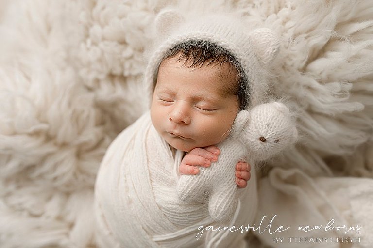sweet newborn baby hugging bear gainesville newborn photography