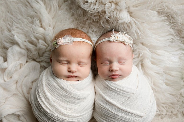 girls wrapped in white newborn photo studio