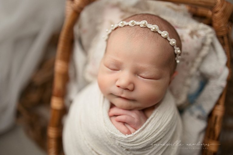 pretty girl swaddled in bamboo basket