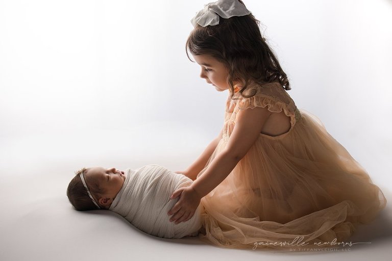 backlit newborn sibling images