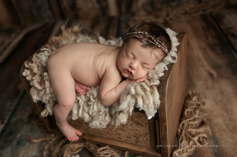 cute baby posed in bed prop