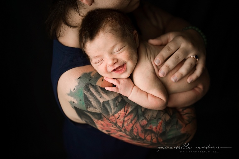 Baby smiling in moms arms gainesville newborn photographer