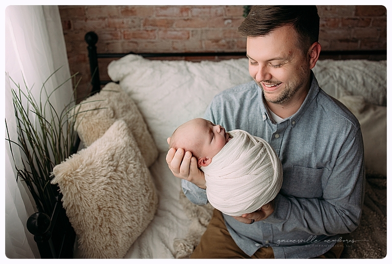 dad holding newborn son newberry photo studio