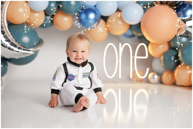 top gun,gainesville,florida,ocala,lake city,first birthday,one year old,cake smash,custom cake smash set,balloon garland,party,almost one,newborn to birthday,growing up,professional photography studio,premier cake smash photographer,celebrate,uf shands,hca north florida,first birthday cake,cake topper,theme,messy,icing,