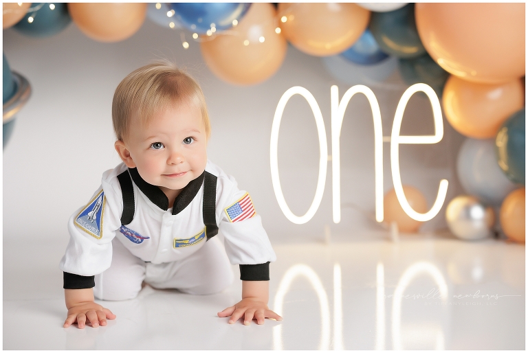 top gun,gainesville,florida,ocala,lake city,first birthday,one year old,cake smash,custom cake smash set,balloon garland,party,almost one,newborn to birthday,growing up,professional photography studio,premier cake smash photographer,celebrate,uf shands,hca north florida,first birthday cake,cake topper,theme,messy,icing,
