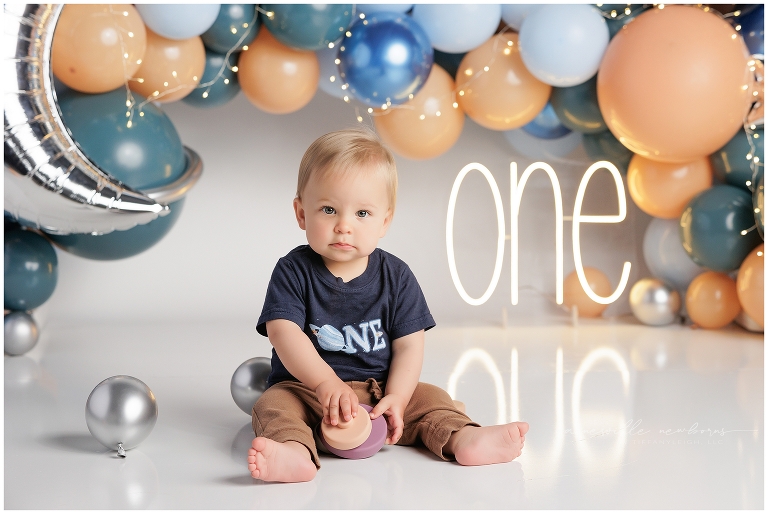 top gun,gainesville,florida,ocala,lake city,first birthday,one year old,cake smash,custom cake smash set,balloon garland,party,almost one,newborn to birthday,growing up,professional photography studio,premier cake smash photographer,celebrate,uf shands,hca north florida,first birthday cake,cake topper,theme,messy,icing,