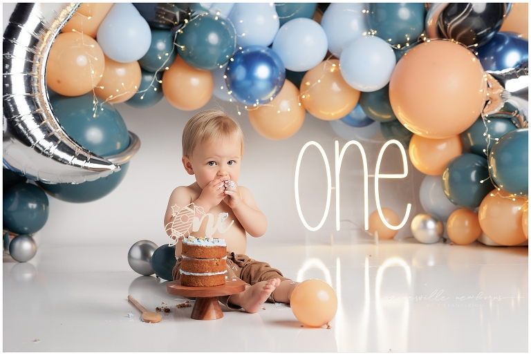 top gun,gainesville,florida,ocala,lake city,first birthday,one year old,cake smash,custom cake smash set,balloon garland,party,almost one,newborn to birthday,growing up,professional photography studio,premier cake smash photographer,celebrate,uf shands,hca north florida,first birthday cake,cake topper,theme,messy,icing,