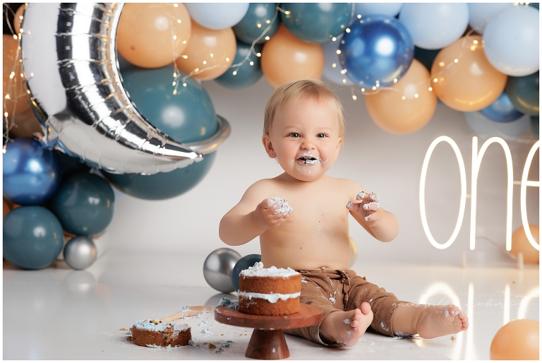 top gun,gainesville,florida,ocala,lake city,first birthday,one year old,cake smash,custom cake smash set,balloon garland,party,almost one,newborn to birthday,growing up,professional photography studio,premier cake smash photographer,celebrate,uf shands,hca north florida,first birthday cake,cake topper,theme,messy,icing,