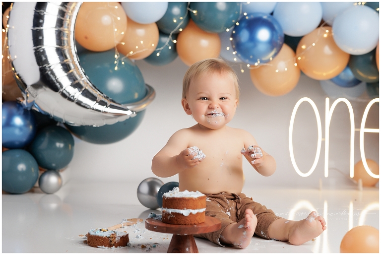 top gun,gainesville,florida,ocala,lake city,first birthday,one year old,cake smash,custom cake smash set,balloon garland,party,almost one,newborn to birthday,growing up,professional photography studio,premier cake smash photographer,celebrate,uf shands,hca north florida,first birthday cake,cake topper,theme,messy,icing,