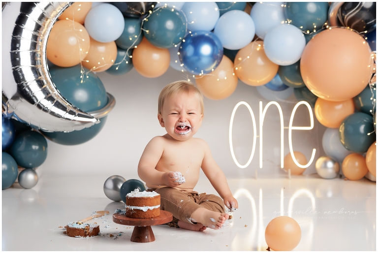 top gun,gainesville,florida,ocala,lake city,first birthday,one year old,cake smash,custom cake smash set,balloon garland,party,almost one,newborn to birthday,growing up,professional photography studio,premier cake smash photographer,celebrate,uf shands,hca north florida,first birthday cake,cake topper,theme,messy,icing,