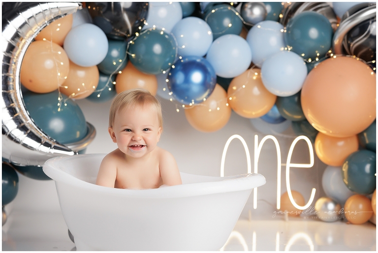 top gun,gainesville,florida,ocala,lake city,first birthday,one year old,cake smash,custom cake smash set,balloon garland,party,almost one,newborn to birthday,growing up,professional photography studio,premier cake smash photographer,celebrate,uf shands,hca north florida,first birthday cake,cake topper,theme,messy,icing,