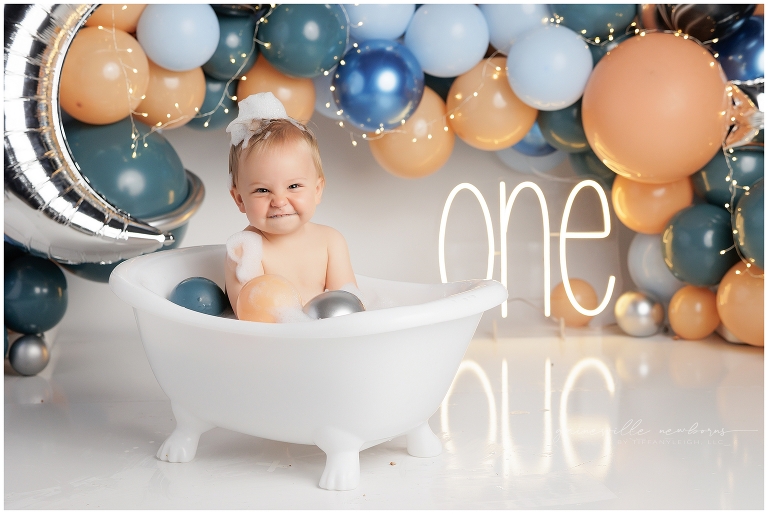 top gun,gainesville,florida,ocala,lake city,first birthday,one year old,cake smash,custom cake smash set,balloon garland,party,almost one,newborn to birthday,growing up,professional photography studio,premier cake smash photographer,celebrate,uf shands,hca north florida,first birthday cake,cake topper,theme,messy,icing,