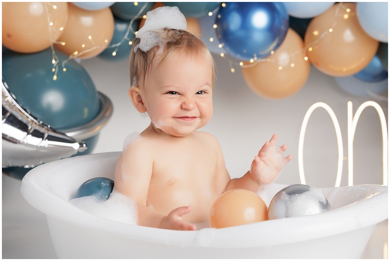 top gun,gainesville,florida,ocala,lake city,first birthday,one year old,cake smash,custom cake smash set,balloon garland,party,almost one,newborn to birthday,growing up,professional photography studio,premier cake smash photographer,celebrate,uf shands,hca north florida,first birthday cake,cake topper,theme,messy,icing,