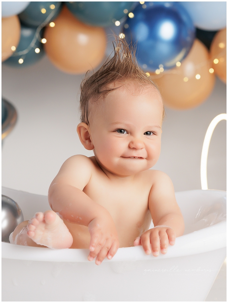 top gun,gainesville,florida,ocala,lake city,first birthday,one year old,cake smash,custom cake smash set,balloon garland,party,almost one,newborn to birthday,growing up,professional photography studio,premier cake smash photographer,celebrate,uf shands,hca north florida,first birthday cake,cake topper,theme,messy,icing,