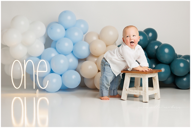 top gun,gainesville,florida,ocala,lake city,first birthday,one year old,cake smash,custom cake smash set,balloon garland,party,almost one,newborn to birthday,growing up,professional photography studio,premier cake smash photographer,celebrate,uf shands,hca north florida,first birthday cake,cake topper,theme,messy,icing,