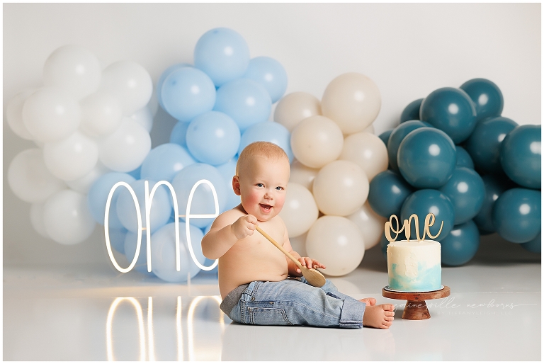 top gun,gainesville,florida,ocala,lake city,first birthday,one year old,cake smash,custom cake smash set,balloon garland,party,almost one,newborn to birthday,growing up,professional photography studio,premier cake smash photographer,celebrate,uf shands,hca north florida,first birthday cake,cake topper,theme,messy,icing,