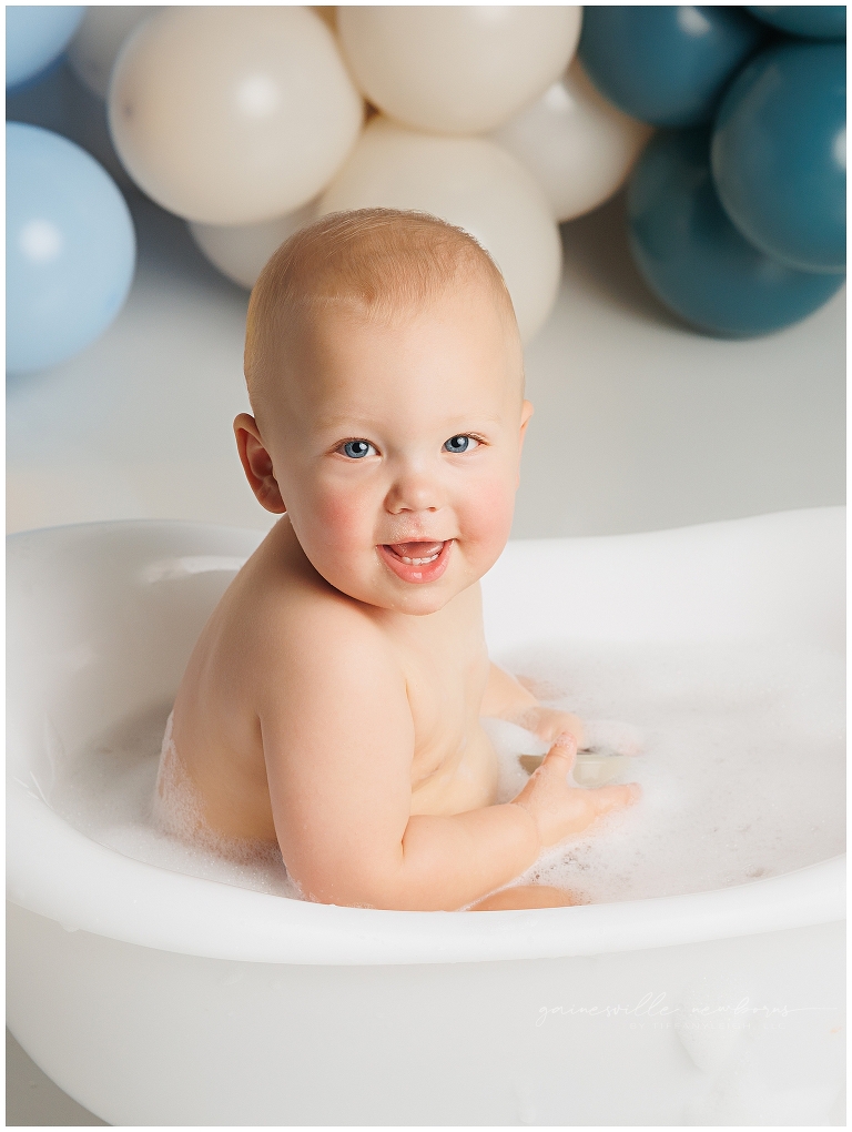 top gun,gainesville,florida,ocala,lake city,first birthday,one year old,cake smash,custom cake smash set,balloon garland,party,almost one,newborn to birthday,growing up,professional photography studio,premier cake smash photographer,celebrate,uf shands,hca north florida,first birthday cake,cake topper,theme,messy,icing,