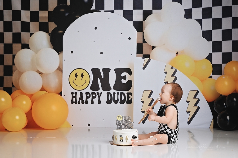 top gun,gainesville,florida,ocala,lake city,first birthday,one year old,cake smash,custom cake smash set,balloon garland,party,almost one,newborn to birthday,growing up,professional photography studio,premier cake smash photographer,celebrate,uf shands,hca north florida,first birthday cake,cake topper,theme,messy,icing,